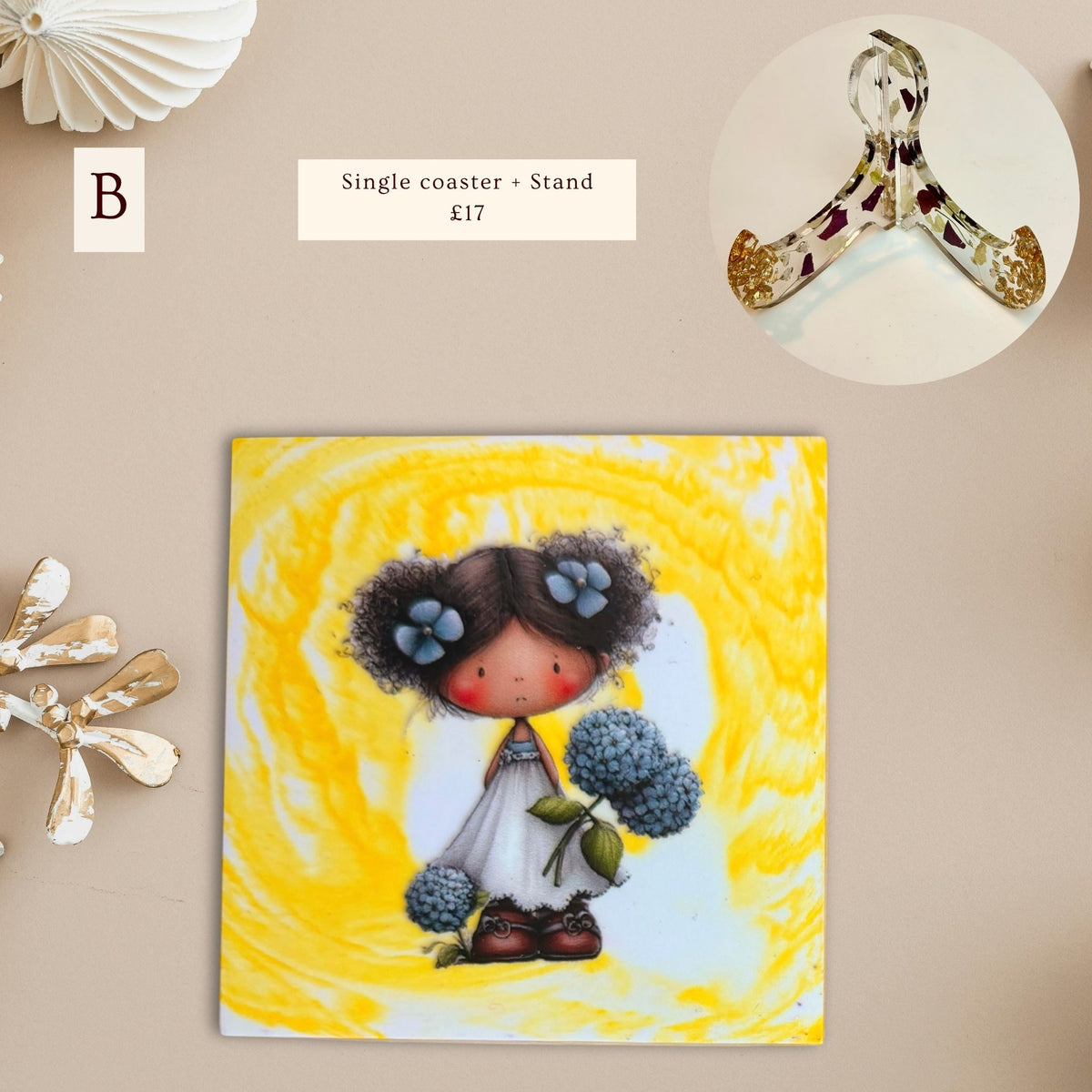 Little Moments eco-ceramic coaster featuring a little girl with dark hair holding blue flowers against a yellow and white marble-effect background.