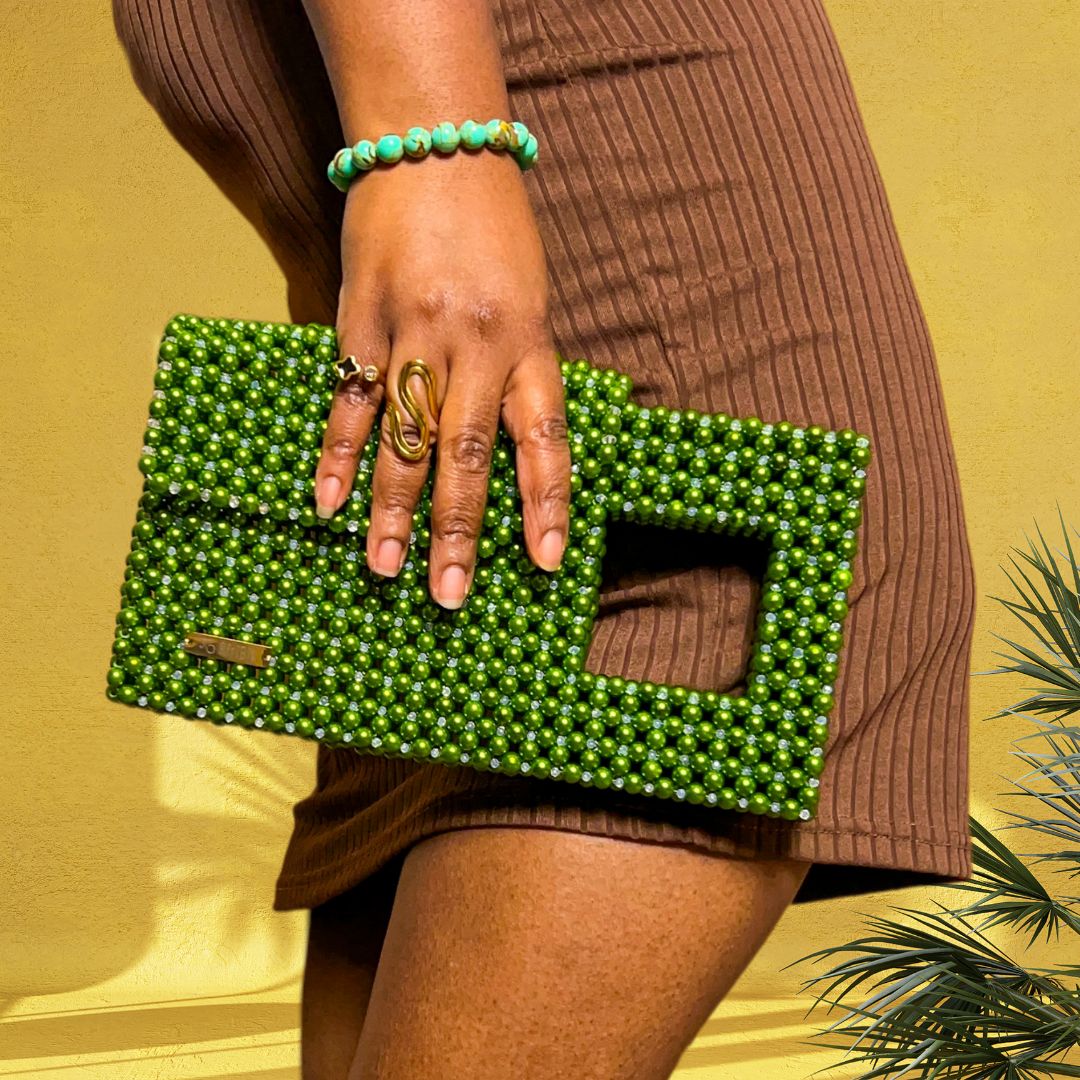 AfriBix Lume green stylish crystal statement clutch handbag 2025. model carrying a green handbag clutch