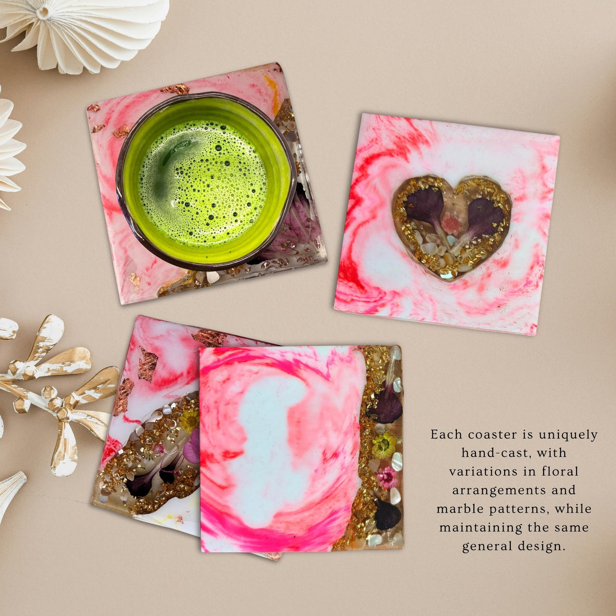 Set of four handmade pink marble-effect coasters with floral details, decorative stones and translucent edges